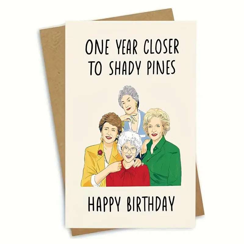 Birthday card with a brown envelope behind it, set against a white background. The card features cartoon-style illustrations of four older women standing together and smiling. The text on the card reads 'ONE YEAR CLOSER TO SHADY PINES' at the top and 'HAPPY BIRTHDAY' at the bottom.