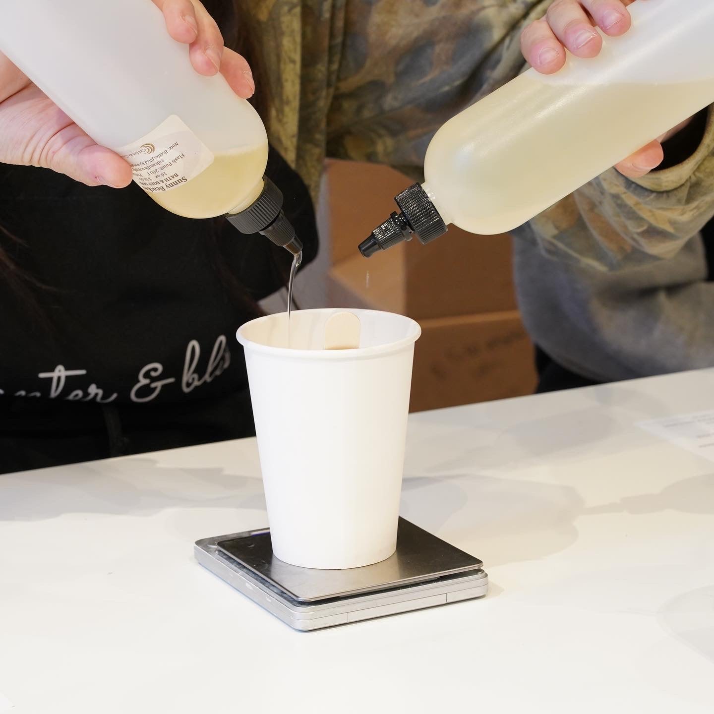 Measuring fragrance for candlemaking at Banter & Bliss