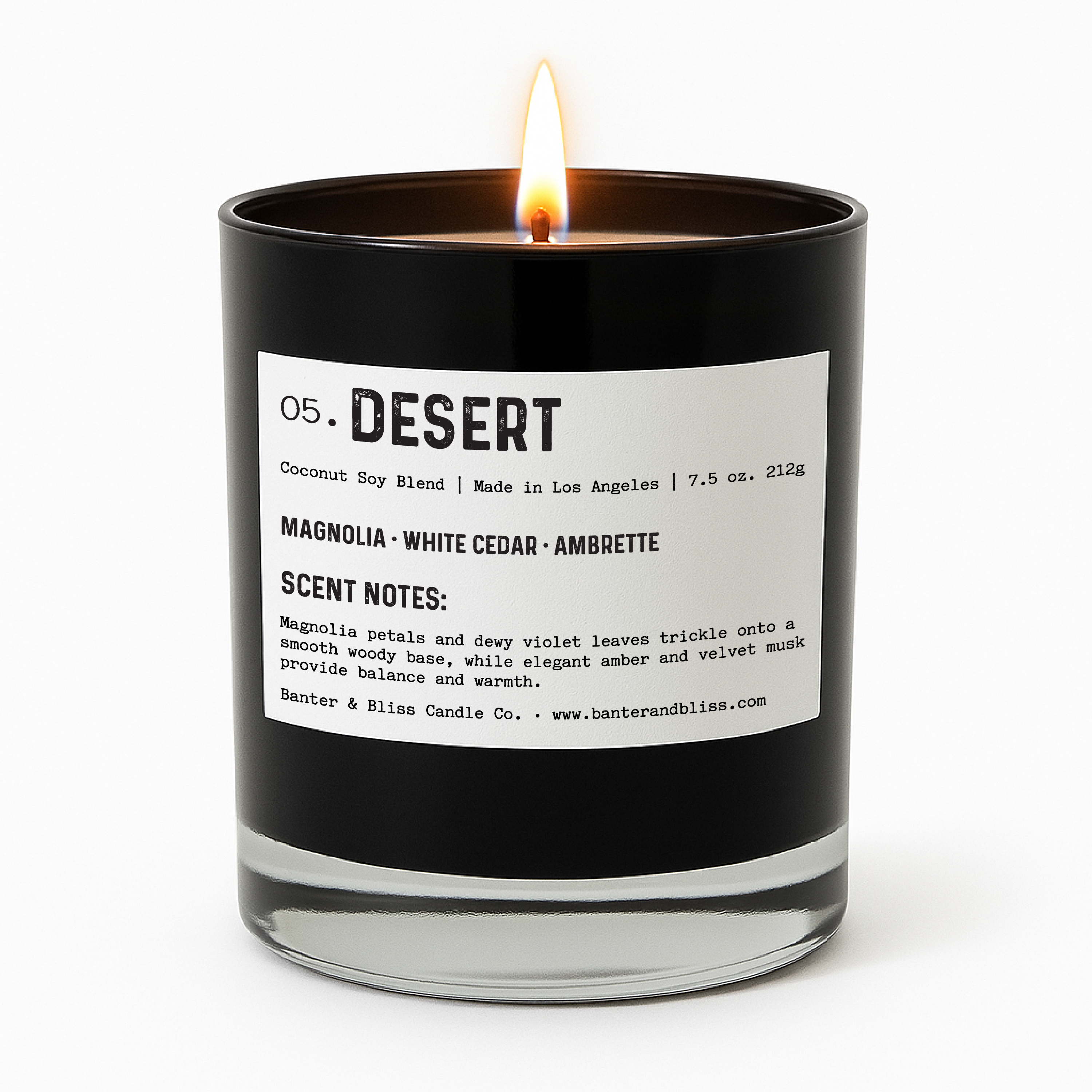 Lit black candle labeled “05. DESERT” featuring scent notes of magnolia, white cedar, and ambrette. The candle is centered on a white background in a sleek, minimalist style.