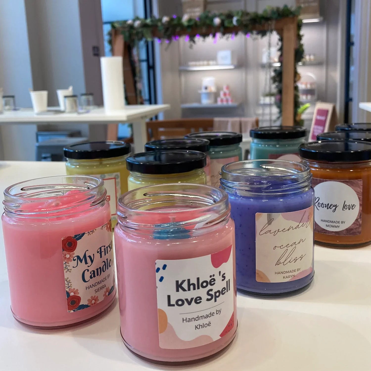 Finished standard jar workshop candles on a table.