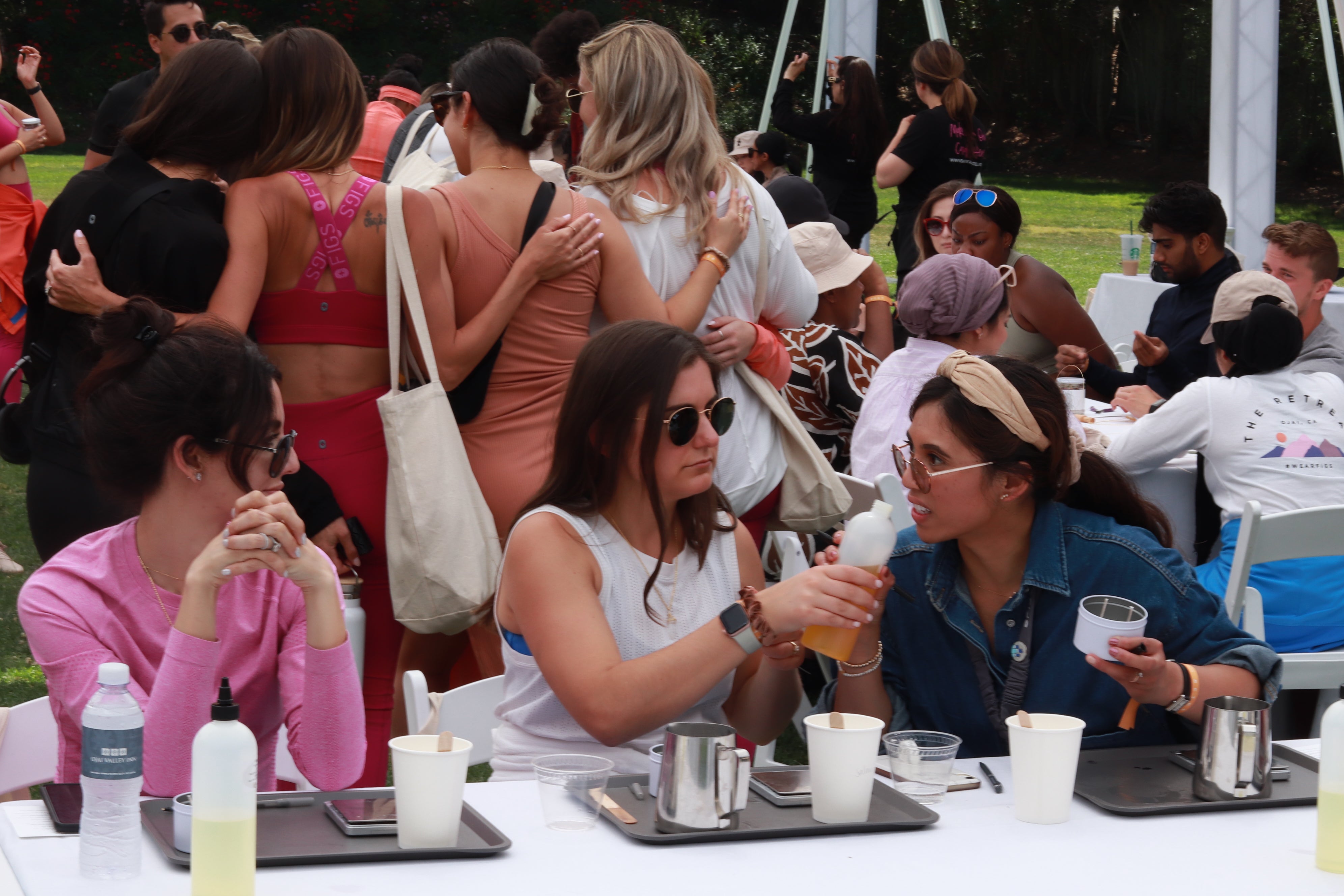 Ladies in a candlemaking workshop smelling fragrances.