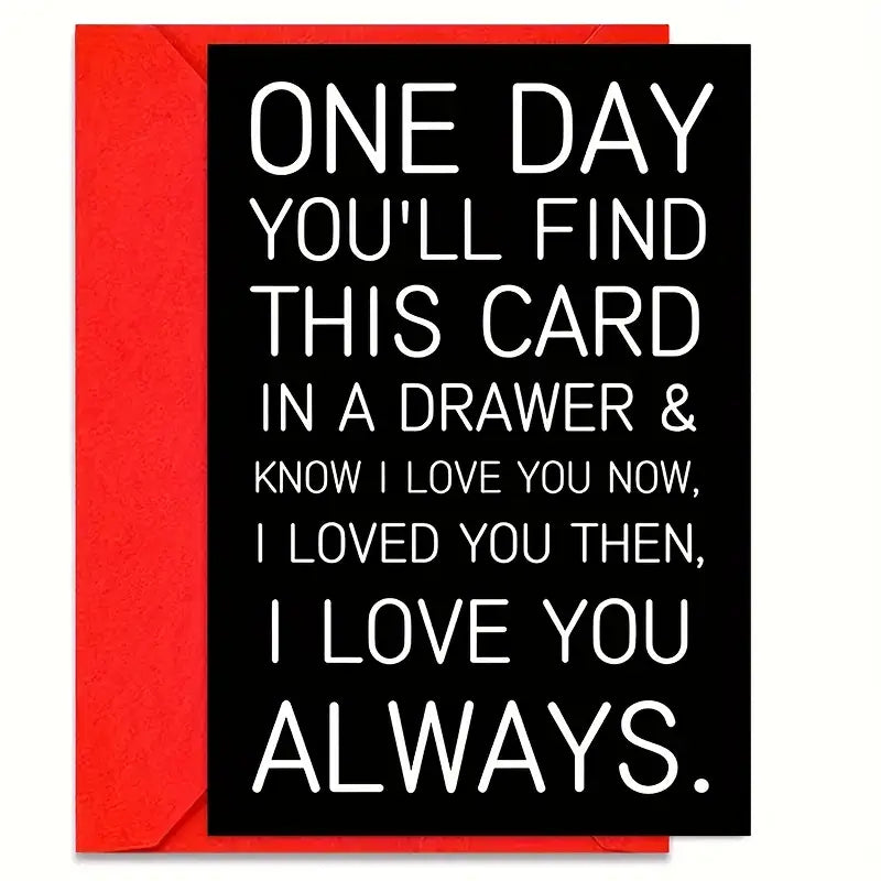 Black greeting card with bold white text that reads: 'ONE DAY YOU’LL FIND THIS CARD IN A DRAWER & KNOW I LOVE YOU NOW, I LOVED YOU THEN, I LOVE YOU ALWAYS.' The card is paired with a red envelope, both placed on a plain white background.