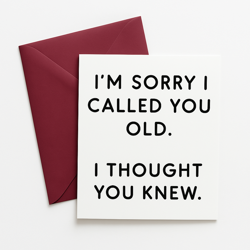 White greeting card with bold black text that reads, 'I'M SORRY I CALLED YOU OLD. I THOUGHT YOU KNEW.' The card is placed on top of a burgundy envelope, both set against a clean white background.