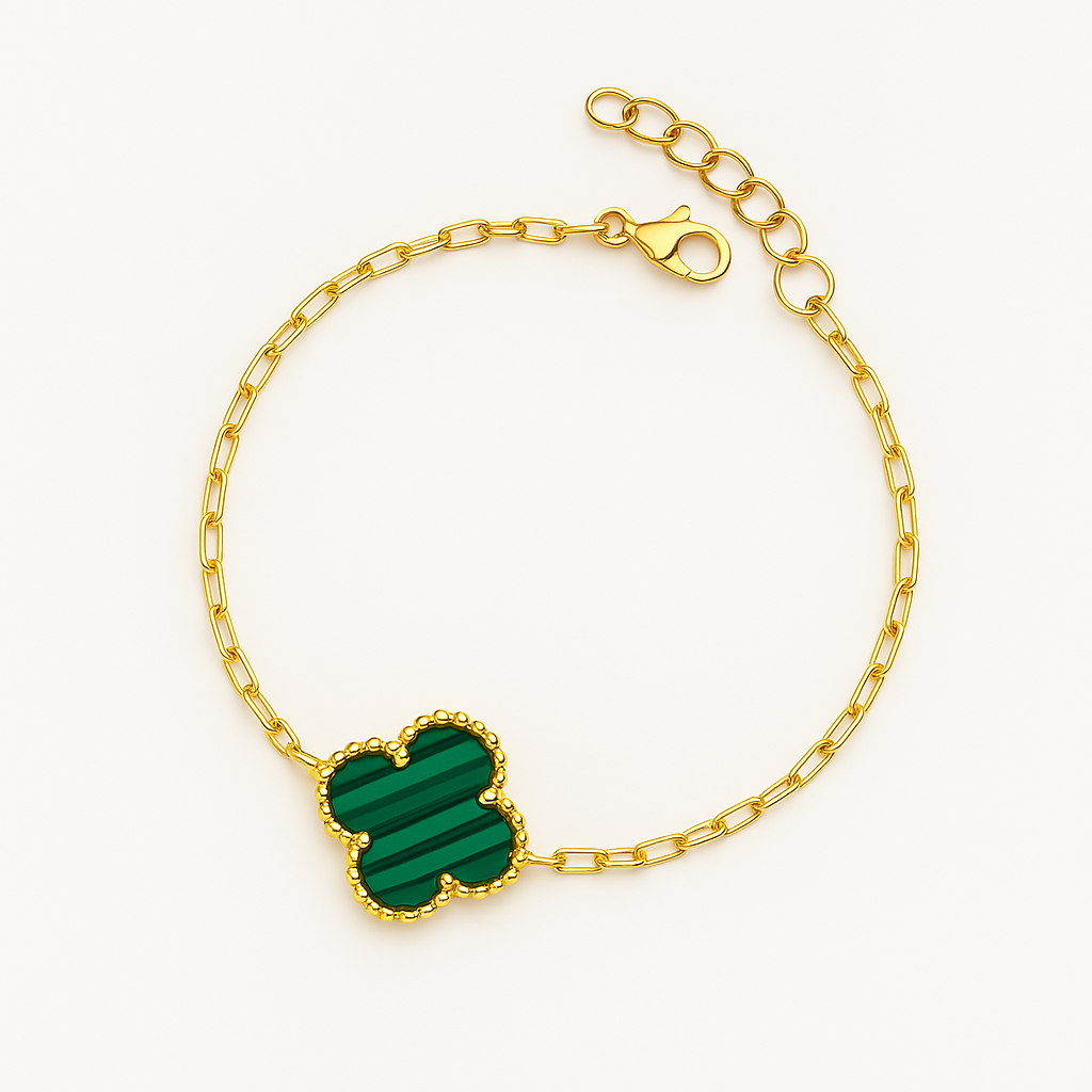 A high-resolution product photo of a gold bracelet arranged in a circular shape on a white background. The bracelet features a clover-shaped green malachite pendant with a beaded gold border and a lobster clasp and extender chain at the top.