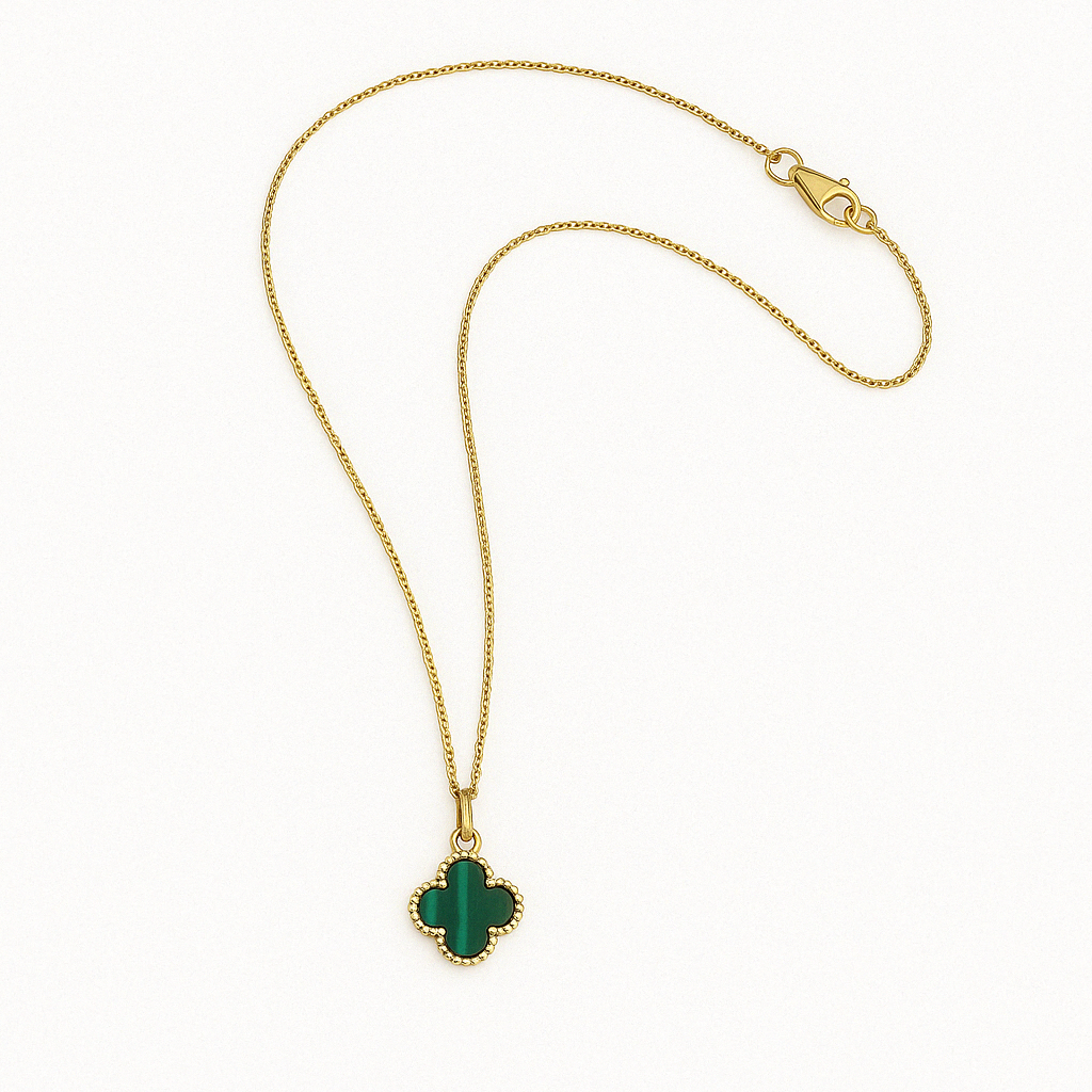 Gold chain necklace with a green malachite clover-shaped pendant and a lobster clasp, laid out flat on a clean white background.