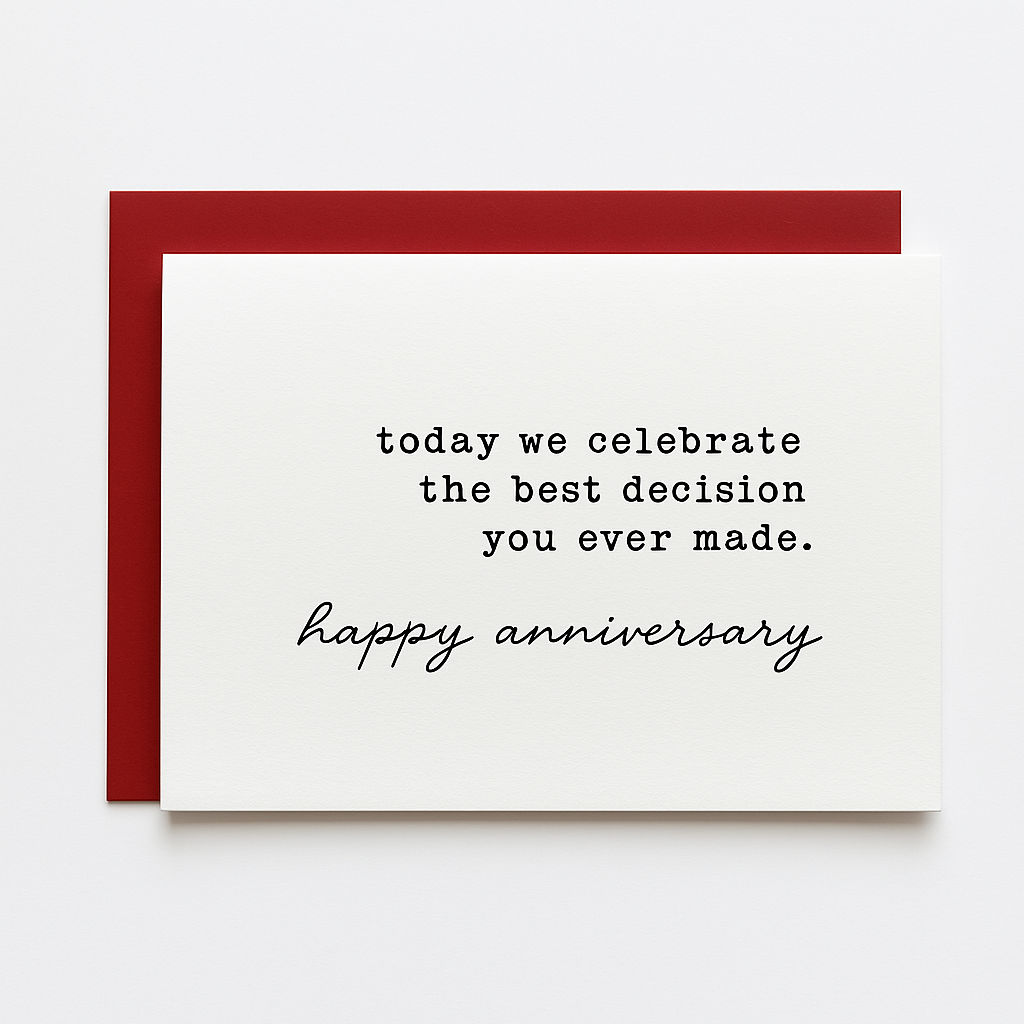 A white anniversary card placed on top of a red envelope, set against a clean white background. The card features a combination of typewriter-style and cursive fonts. The text reads: "today we celebrate the best decision you ever made." followed by "happy anniversary" in elegant script