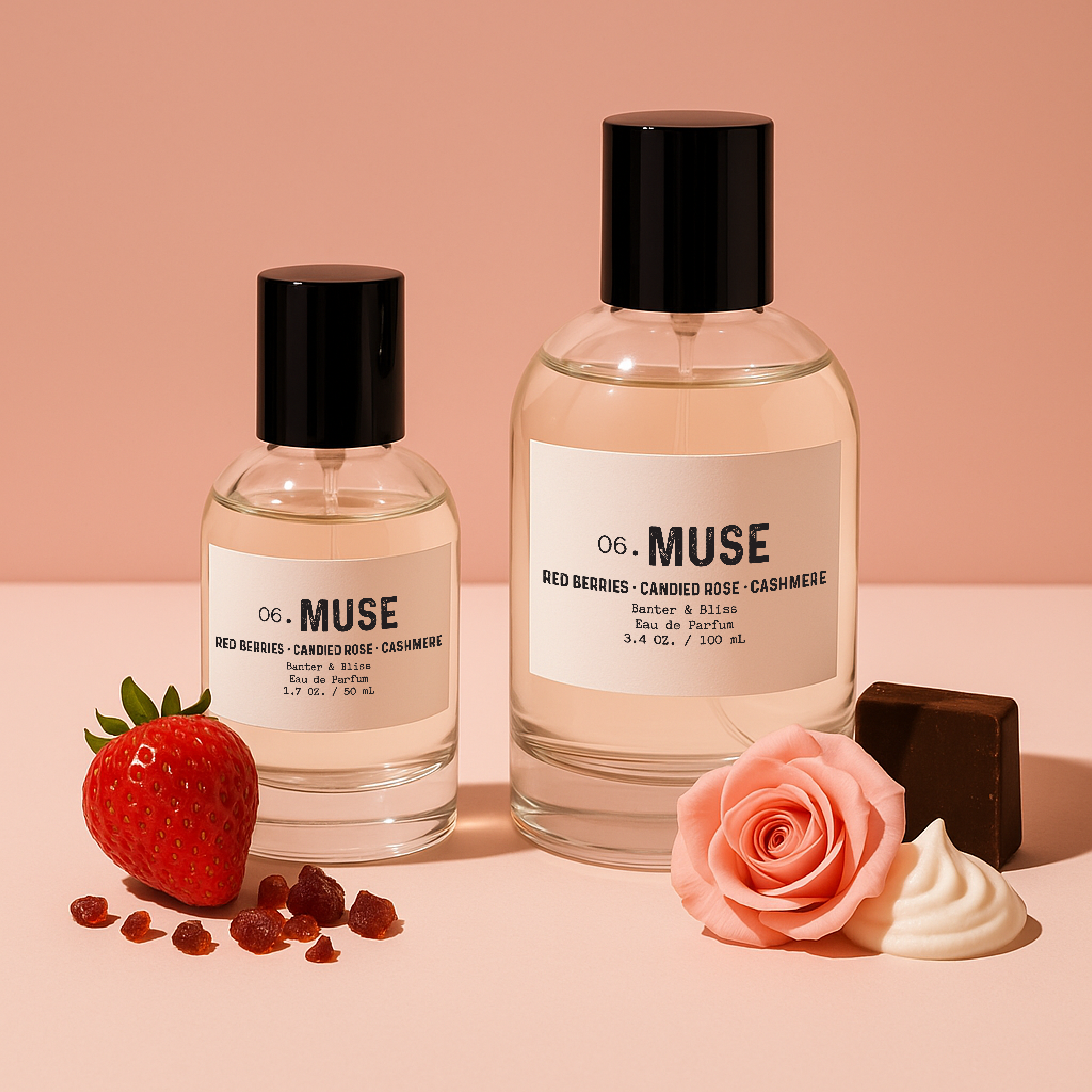 Muse Eau de Parfum by Banter & Bliss – 1.7 oz and 3.4 oz glass bottles styled on a pastel background with red berries, candied rose, whipped vanilla, and dark chocolate accents.