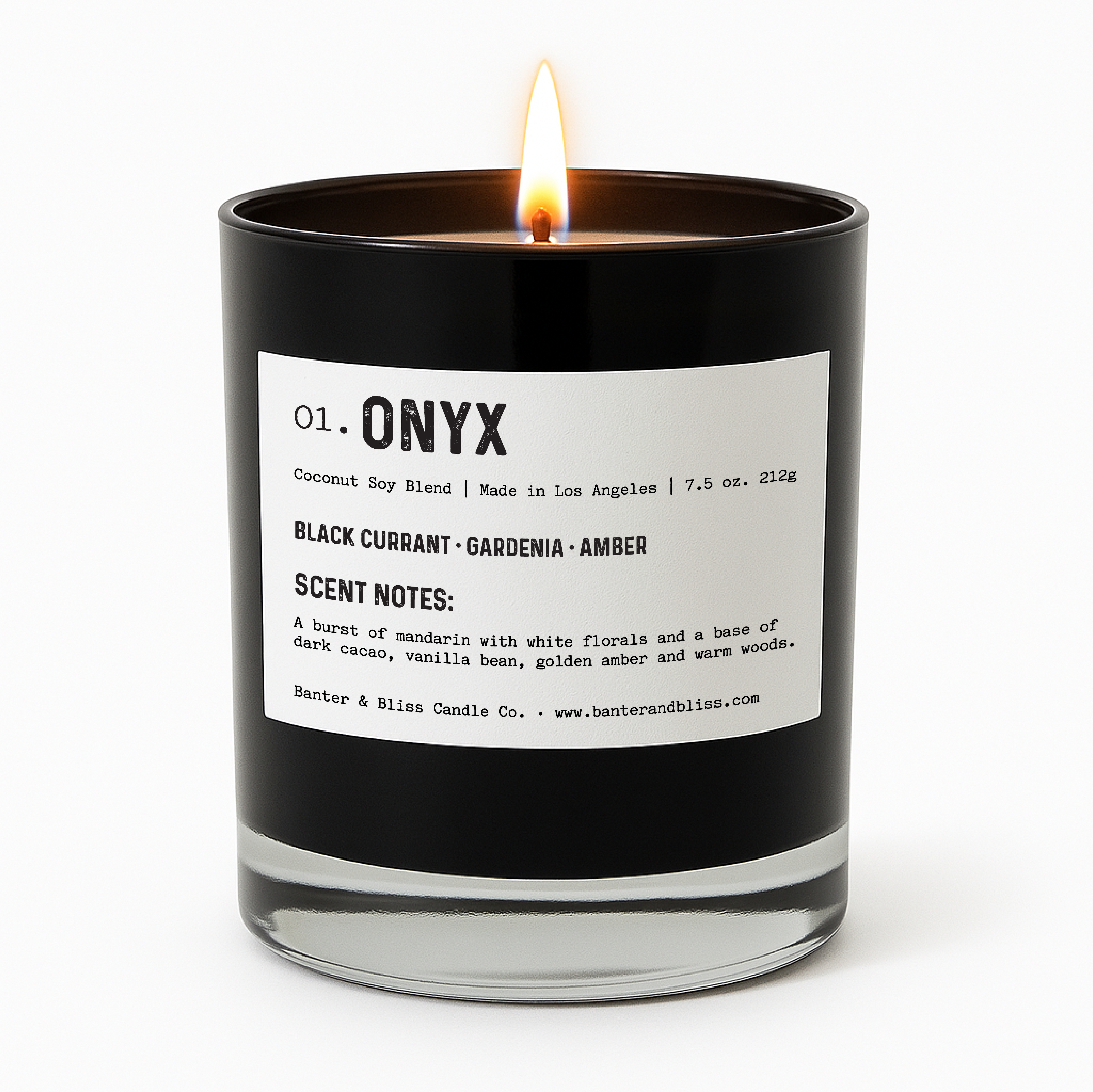 Banter & Bliss "Onyx" candle in a matte black glass jar with white label, lit and styled for product display — featuring scent notes of black currant, gardenia, amber, mandarin, dark cacao, vanilla bean, and warm woods. Coconut soy blend, made in Los Angeles.