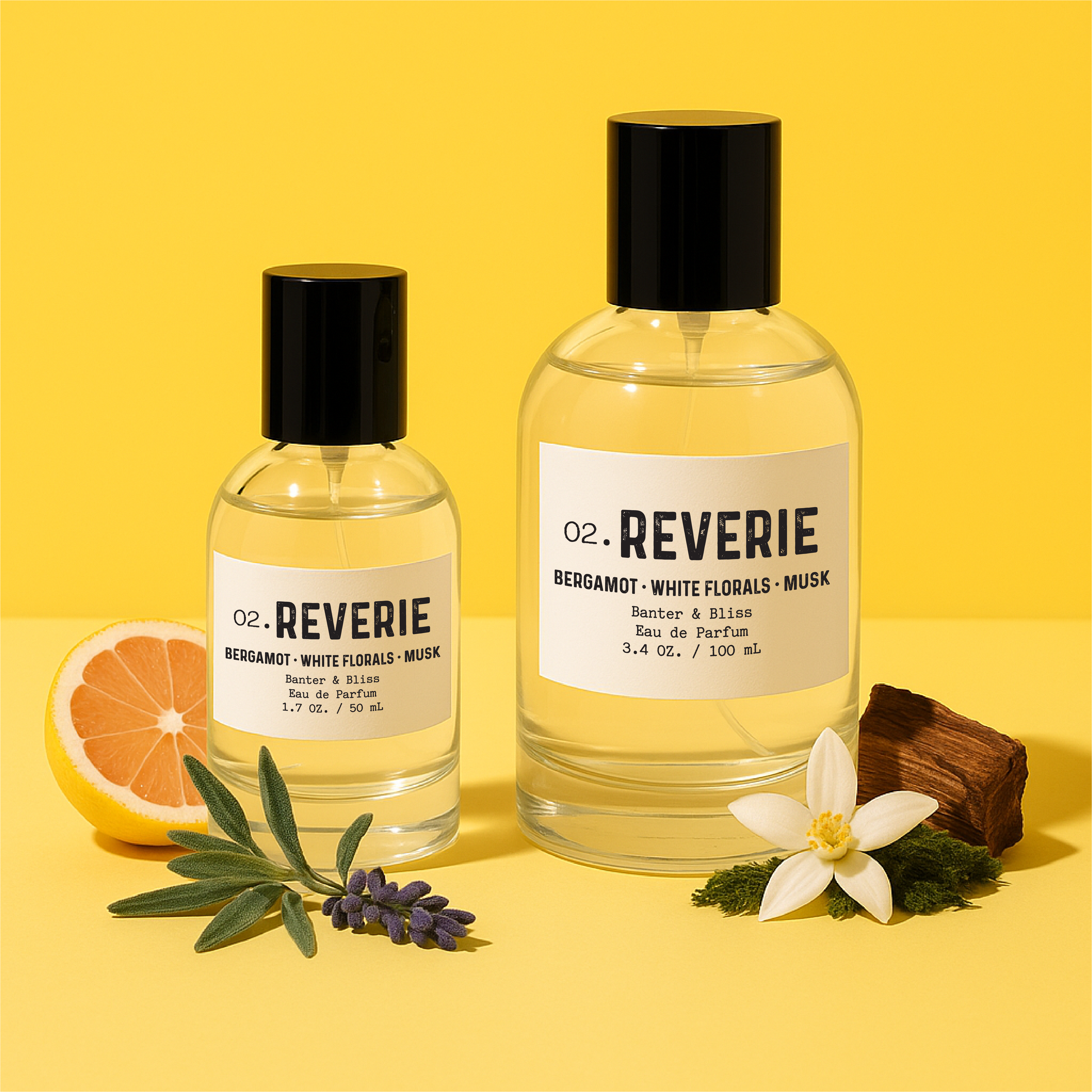 Reverie Eau de Parfum by Banter & Bliss – 1.7 oz and 3.4 oz luxury fragrance bottles styled on a vibrant yellow background with grapefruit, blue sage, orange blossom, moss, and amber wood.