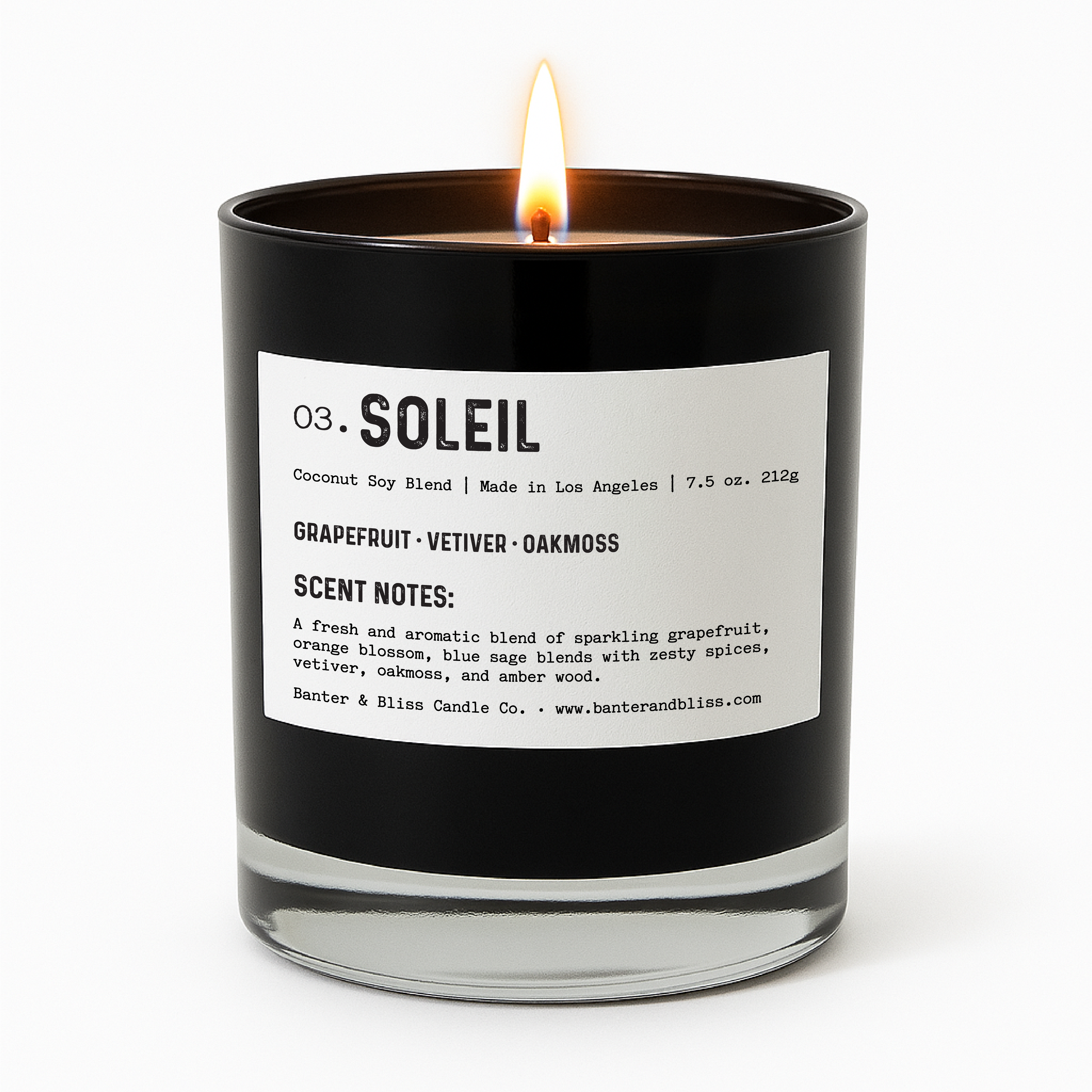 Banter & Bliss "Soleil" candle in a black glass jar with a minimalist white label, lit and styled for product display — featuring scent notes of grapefruit, vetiver, oakmoss, orange blossom, blue sage, and amber wood. Coconut soy blend, made in Los Angeles.