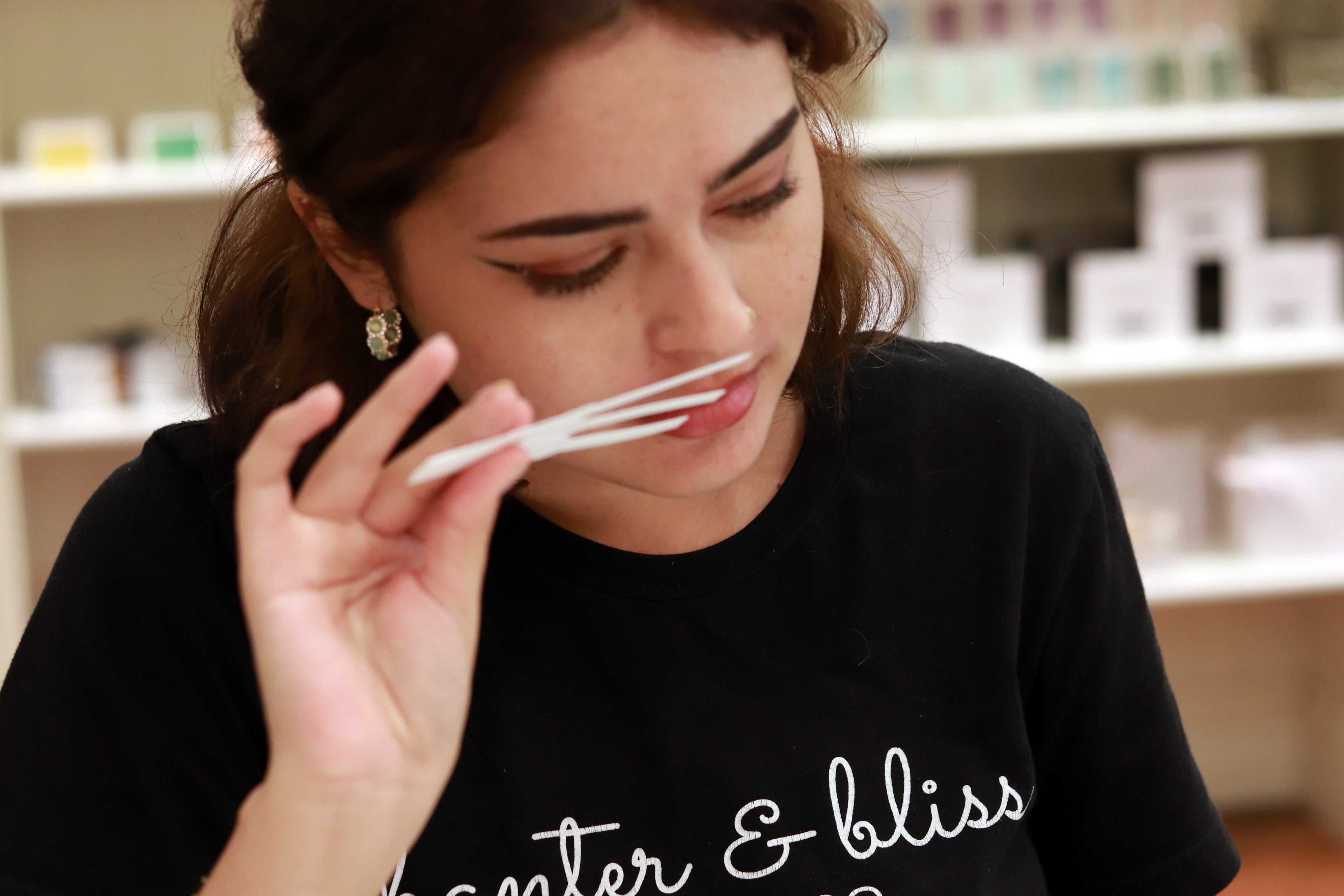 Woman smelling scent strips making perfume