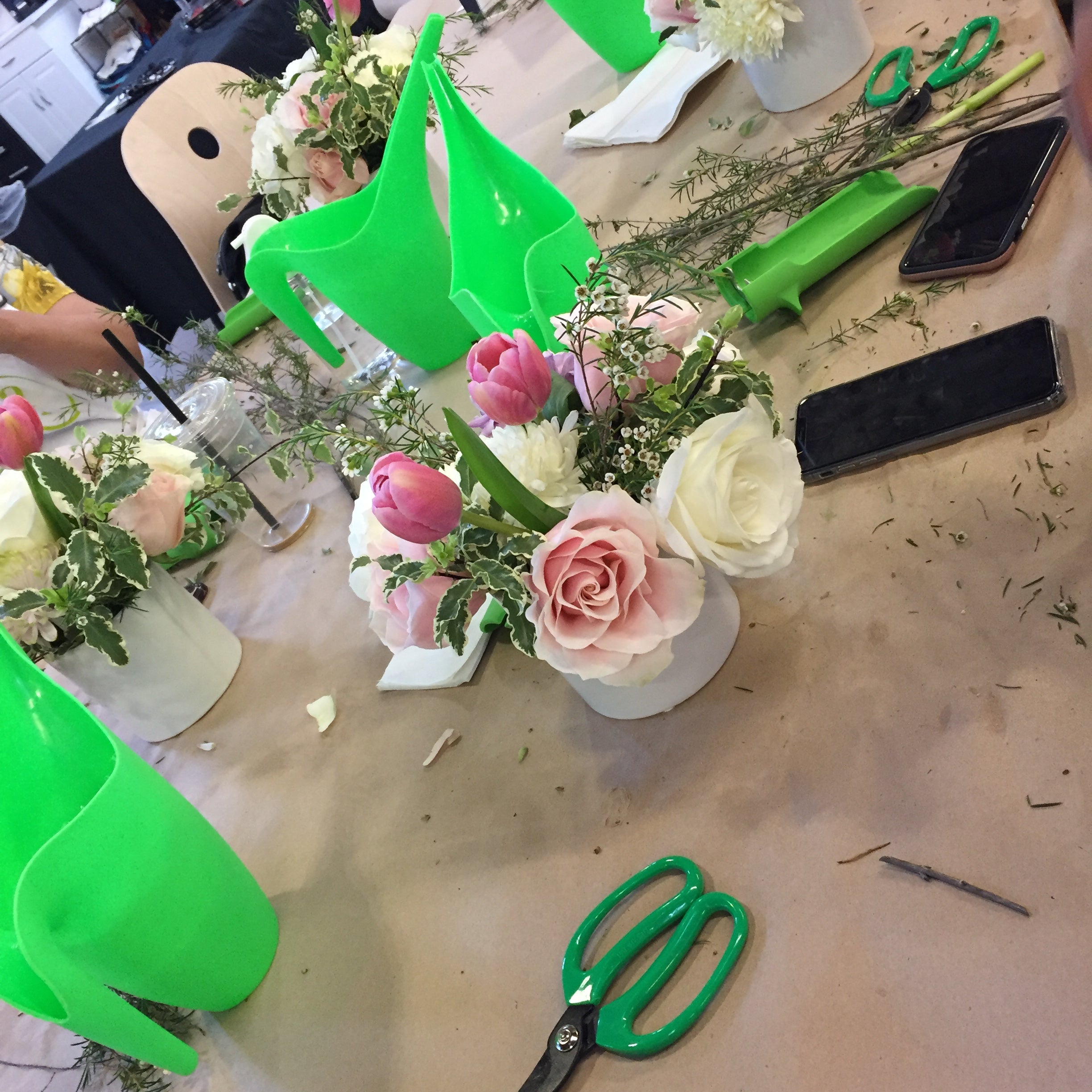 Flower arranging class in session at Banter & Bliss workshop, supplies and tools on a table