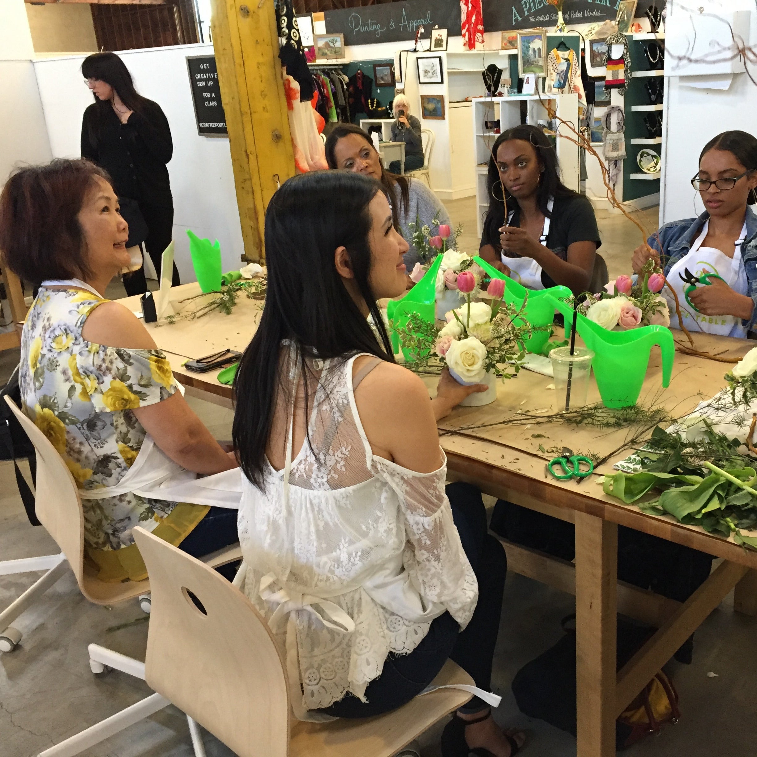 Flower arranging class in session at Banter & Bliss workshop, supplies and tools on a table