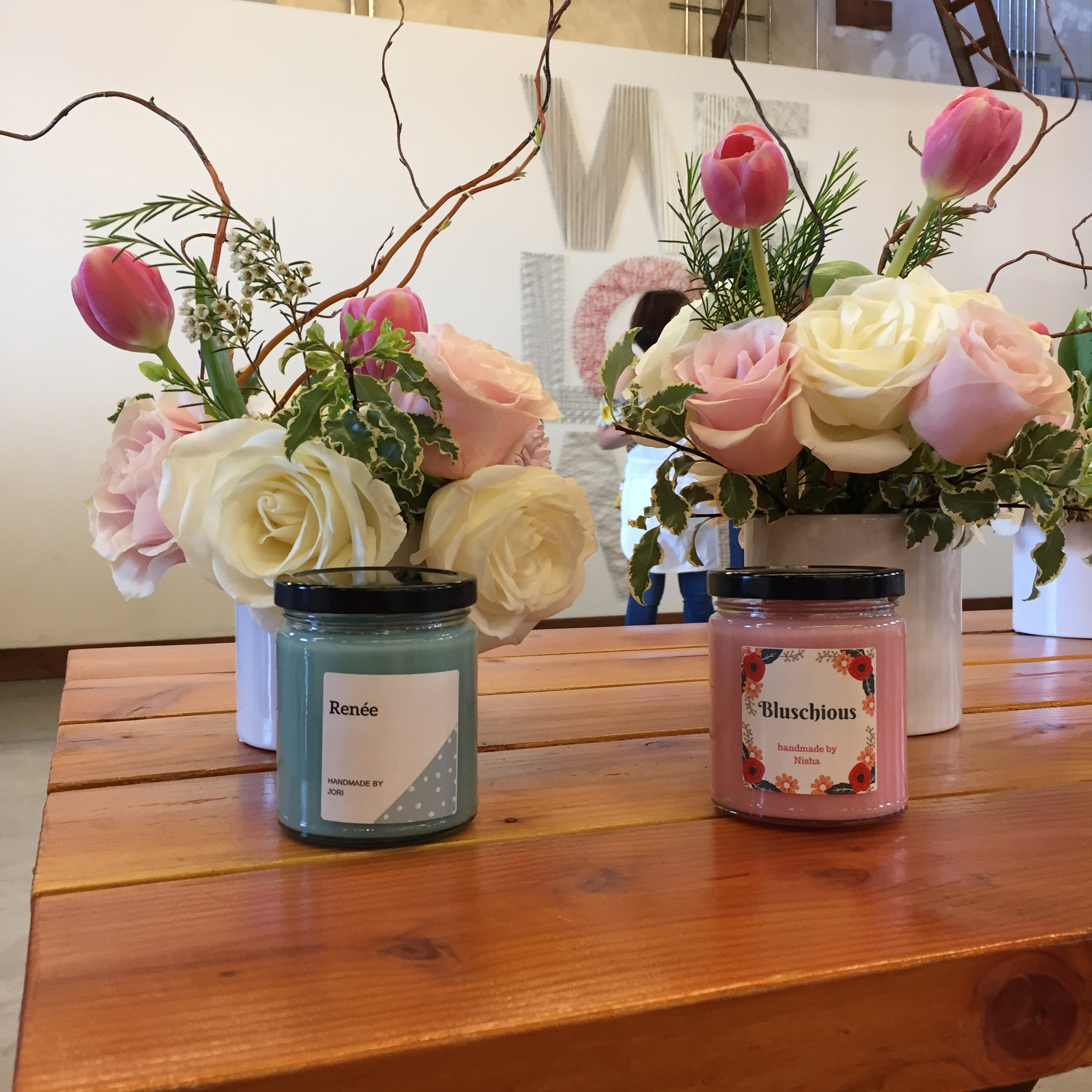 Handmade candles and flower arrangements from a Banter & Bliss workshop